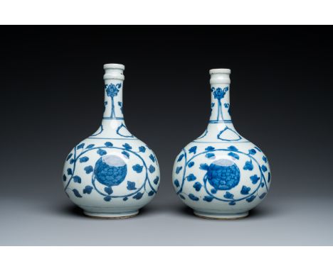 Fullt title: A pair of Chinese blue and white 'peony scroll' pharmacy bottles, KangxiDescription: H.: 24 cm (the tallest) Con