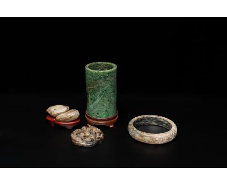 Fullt title: A Chinese jade brush pot, a bangle and two carvings, 19/20th C.Description: H.: 10 cm (the brush pot inc. stand)