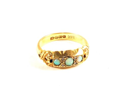 An 18ct Gold ring set with pierced scrollwork shoulders set with three small Opals and four small Diamonds (small chips to on