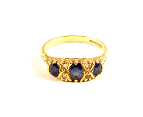 An 18ct Gold three Sapphire set ring interspersed with small Diamonds