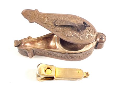 An Indian white metal box with sliding top and peacock finial plus a Solingen plated cigar cutter