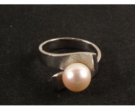 A white metal Pearl set ring, marked Manning, size N