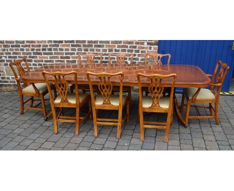 Regency style dining table with 2 leaves, yew wood veneer top and 8 chairs inc 2 carvers in the Chippendale style (extends to