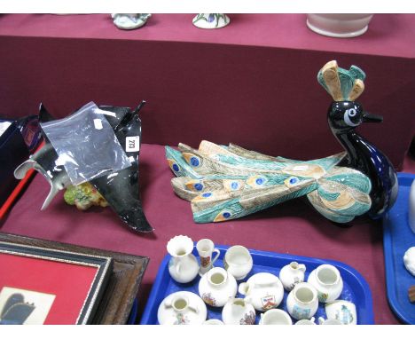 A Goebel Peacock, base impressed 38-940-28 dated 1984, length 39 cms, and a Goebel Atlantic Mauta (damages). (2)