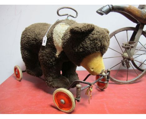 1950 Steiff Ride on Bear, approximately 38cms tall x 53cms long marked Steiff 100' on tyres. Button and label missing from be