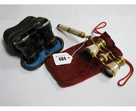 A Pair of Iris Paris Mother of Pearl Opera Glasses, with side handle; together with a black pair in Oriental case. (2)