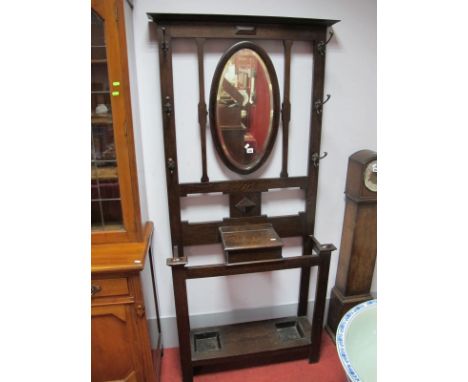 Early XX Century Oak Hall Coat Stick Stand, with a central oval mirror, coat hooks, glove compartment, square supports, under