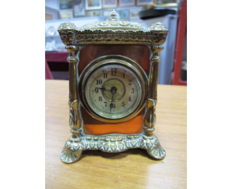 Early XX Century Brass and Copper Mantel Clock, with a finial top, circular dial with bevelled glass, with registration impre