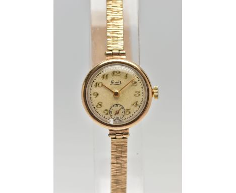 A LADIES 9CT GOLD WRISTWATCH WITH CHARM, hand wound movement, round discoloured dial signed 'Limit', Arabic numerals, subsidi