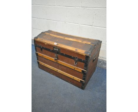A VINTAGE DOMED TOP TRUNK, with wooden and metal banding, width 76cm x depth 46cm x height 54cm (condition:-canvas distressed