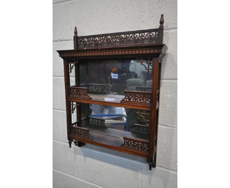 A 20TH CENTURY WALNUT TWO TIER WALL SHELF, with a mirrored back and open fretwork detail, width 54cm x depth 13cm x height 74