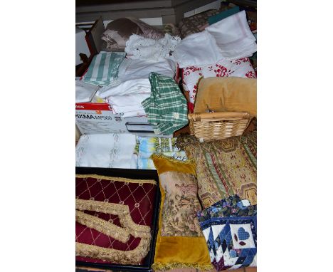 FOUR BOXES OF HOUSEHOLD LINENS, to include throws, cushions, cushion covers, tablecloths and napkins, doilies, a pair of curt