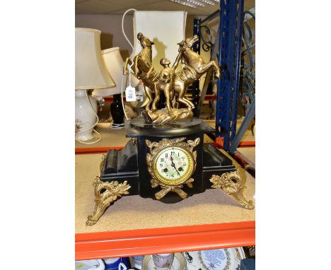 A LATE 19TH CENTURY BLACK SLATE AND GILT METAL FIGURAL MANTEL CLOCK, the case surmounted by two rearing horses and their groo