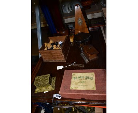 A LARGE OAK TRAY, METRONOME AND CHESS PIECES, comprising a box of thirty two black and red lead chess pieces, a Maelzel metro