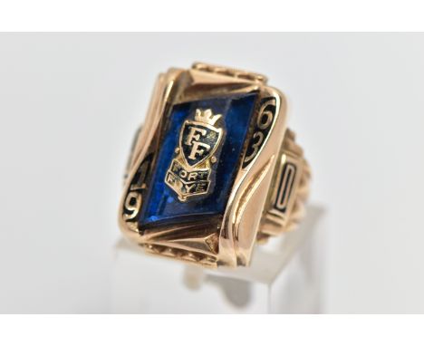 A YELLOW METAL 'HERFF JONES' CLASS RING, rectangular form set with a blue  glass panel, detailed with a school motif for Fort