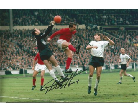 Geoff Hurst, football Autographed 12 X 8 Photo, Depicting The England Forward In An Aerial Duel For The Ball With Germanys Ti