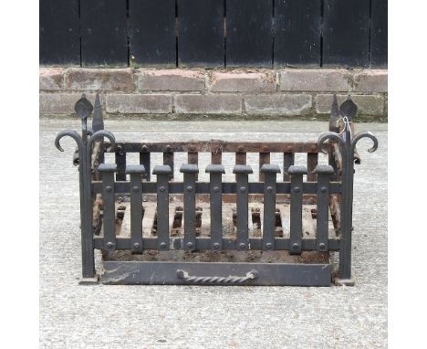 A black painted iron fire grate, 68cm