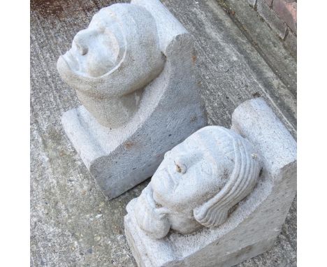 A medieval style carved stone corbel, in the form of a knight, together with another similar, each 35cm high