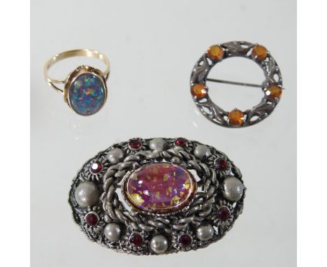 A 9 carat gold opal single stone ring, together with two brooches