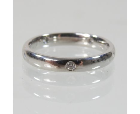 A platinum and diamond full hoop eternity ring, set with five diamonds, K/L, 4.4g gross, boxed