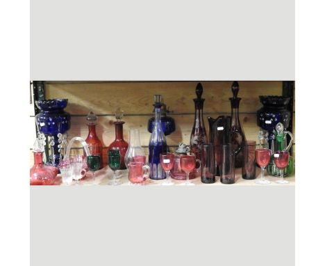 A collection of 19th century and later coloured glassware, to include a blue overlaid decanter and stopper, 35cm high, a pair