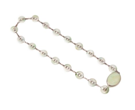 A VINTAGE SILVER AND JADE BELT
Consisting of a oval buckle and hook and eighteen huaigu jade discs connected by silver colour