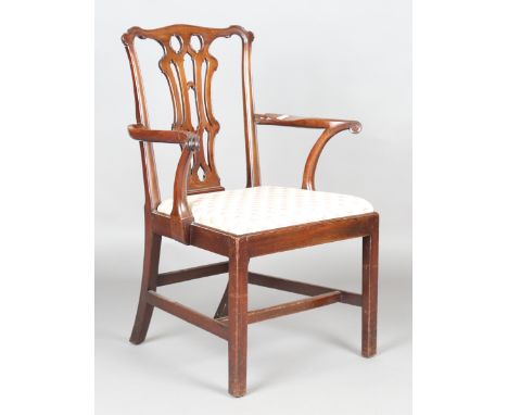 A George III Chippendale period mahogany elbow chair with finely carved and pierced splat back, height 102cm, width 72cm.Buye