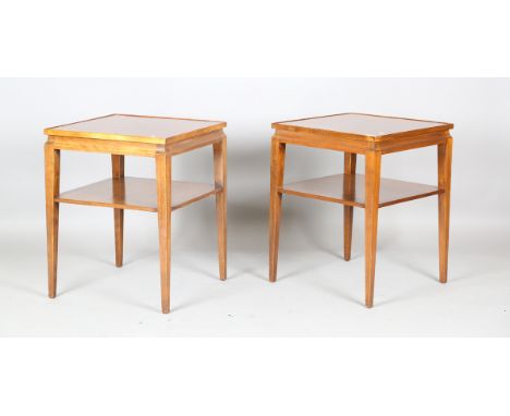 A pair of mid-20th century French mahogany lamp tables of retro design, the quarter-veneered tops above an undertier, height 