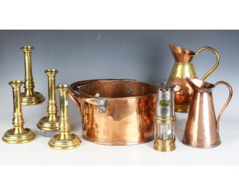 A collection of copper and brassware, including a copper pan, diameter 29cm, a Patterson miner's lamp and various brass candl