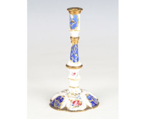 An 18th century South Staffordshire enamel candlestick, decorated with blue panels and flowers against a white ground, with b