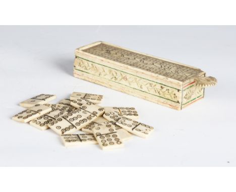 A 19th century prisoner-of-war carved bone games box with sliding cribbage board lid, containing a set of dominoes, length 13