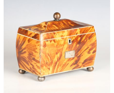 A Regency tortoiseshell tea caddy of sarcophagus form with ivory and white metal banding, raised on silvered copper bun feet,