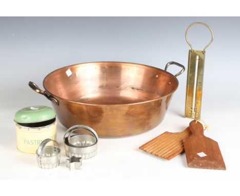 An early 20th century French copper preserve pan, a brass thermometer, two wooden troughs and a small group of other kitchena