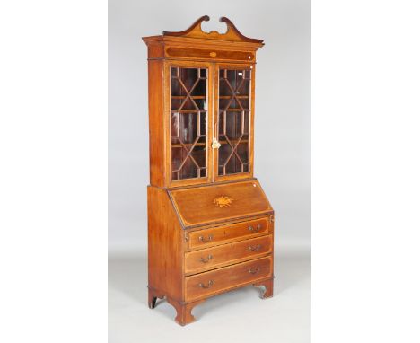 An Edwardian mahogany bureau bookcase with inlaid decoration, the swan neck pediment above a pair of astragal glazed doors, t