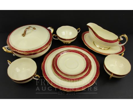 A Royal Albert eight place bone china dinner service, dark red border with gilt decoration, comprising eight soup bowls &amp;