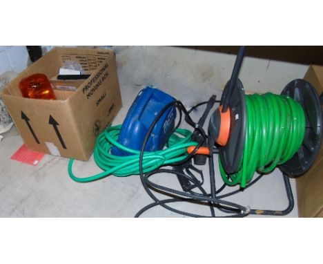 An Assorted Lot to include an amber alert light, garden hoses, etc.