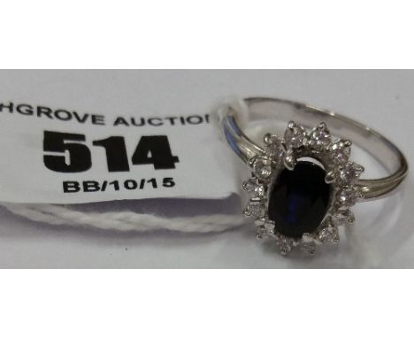 An 18ct Diamond and Sapphire Cluster Ring.