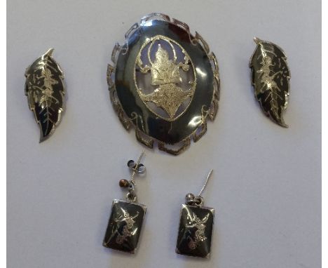 A Silver Enamel Broach, along with two pairs of silver earrings.