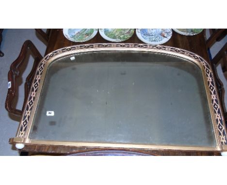 A Victorian Gilt Framed Overmantel Mirror of Arched Form, with running stylised floral detail raised on white glazed ceramic 