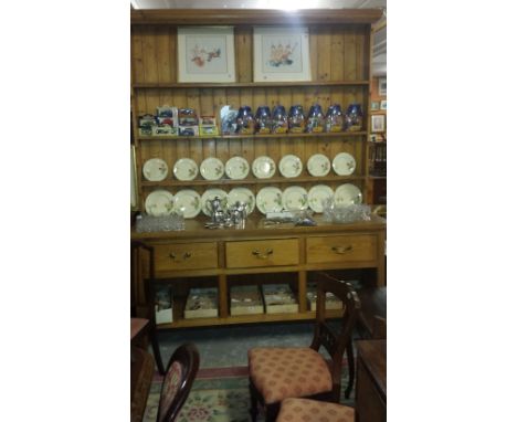 A Large Pine Kitchen Dresser, with plank back top above a base of three frieze drawers and open platform shelf, 250 cm high, 