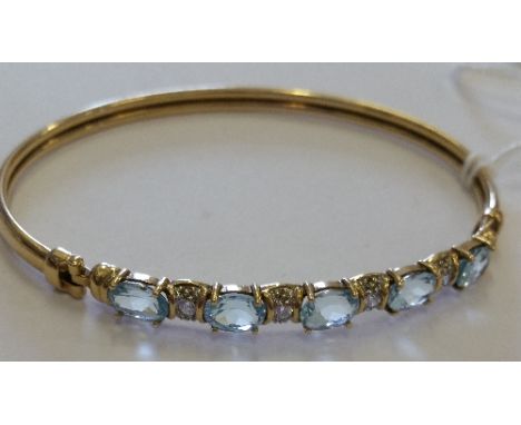 A 9ct Aquamarine Cluster Bangle.