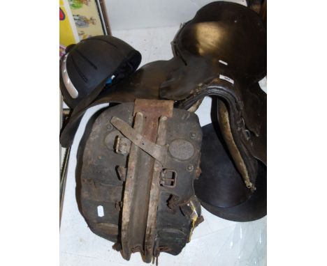 A Leather Saddle, a Helmet and a Donkey's Yoke.