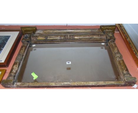 A Regency Giltwood and Gesso Overmantel Mirror, with a moulded cornice of recessed broken outline and inset rectangular plate