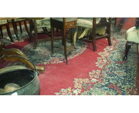 A Persian Red Ground Carpet; the central medallion and scrolling floral detail within running borders, 400 x 275 cm approx.