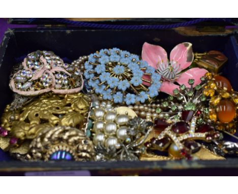 A small jewellery box containing a selection of costume jewellery including brooches