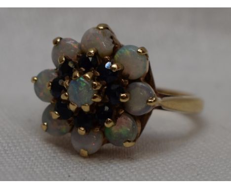 A lady's dress ring having a sapphire and opal triple cluster in a claw set basket mount on a 9ct gold loop, AF size M&nbsp; 