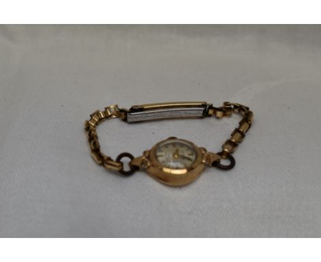 A lady's 9ct gold wrist watch by Rotary having a baton numeral dial to small circular face on a gold plated strap