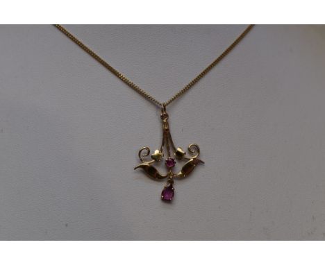 A yellow metal Edwardian style pendant and chain stamped 9K having ruby decoration, chain approx 18'
Condition Report. This i