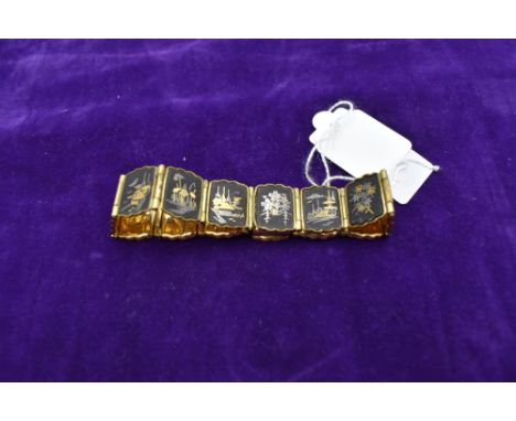 A vintage Japanese damascene articulated bracelet by Amita having fourteen scenic panels with concealed box clasp stamped K24
