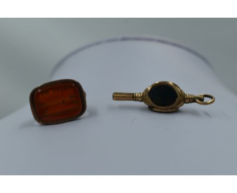 A yellow metal watch fob bearing a 'tally Ho' fox intaglio and a watch key having chalcedony and blood stone decoration